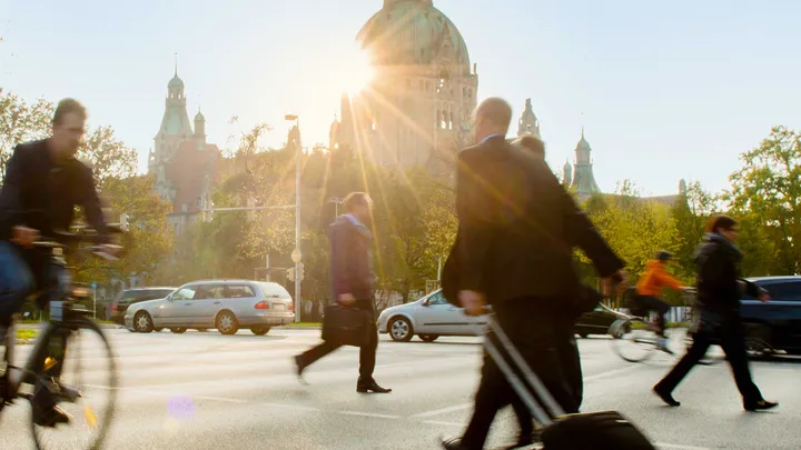 Verkehrsteilnehmende vor dem Neuen Rathaus in Hannover